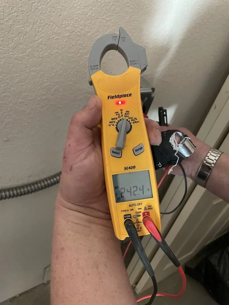 Voltage testing with clamp meter during Ceiling Fan Installation in Queensbury